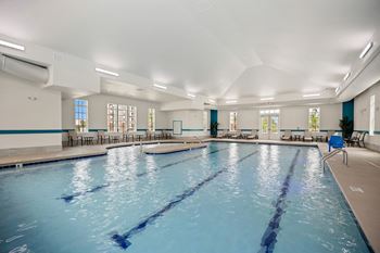 A large swimming pool in a building with a large blue pool